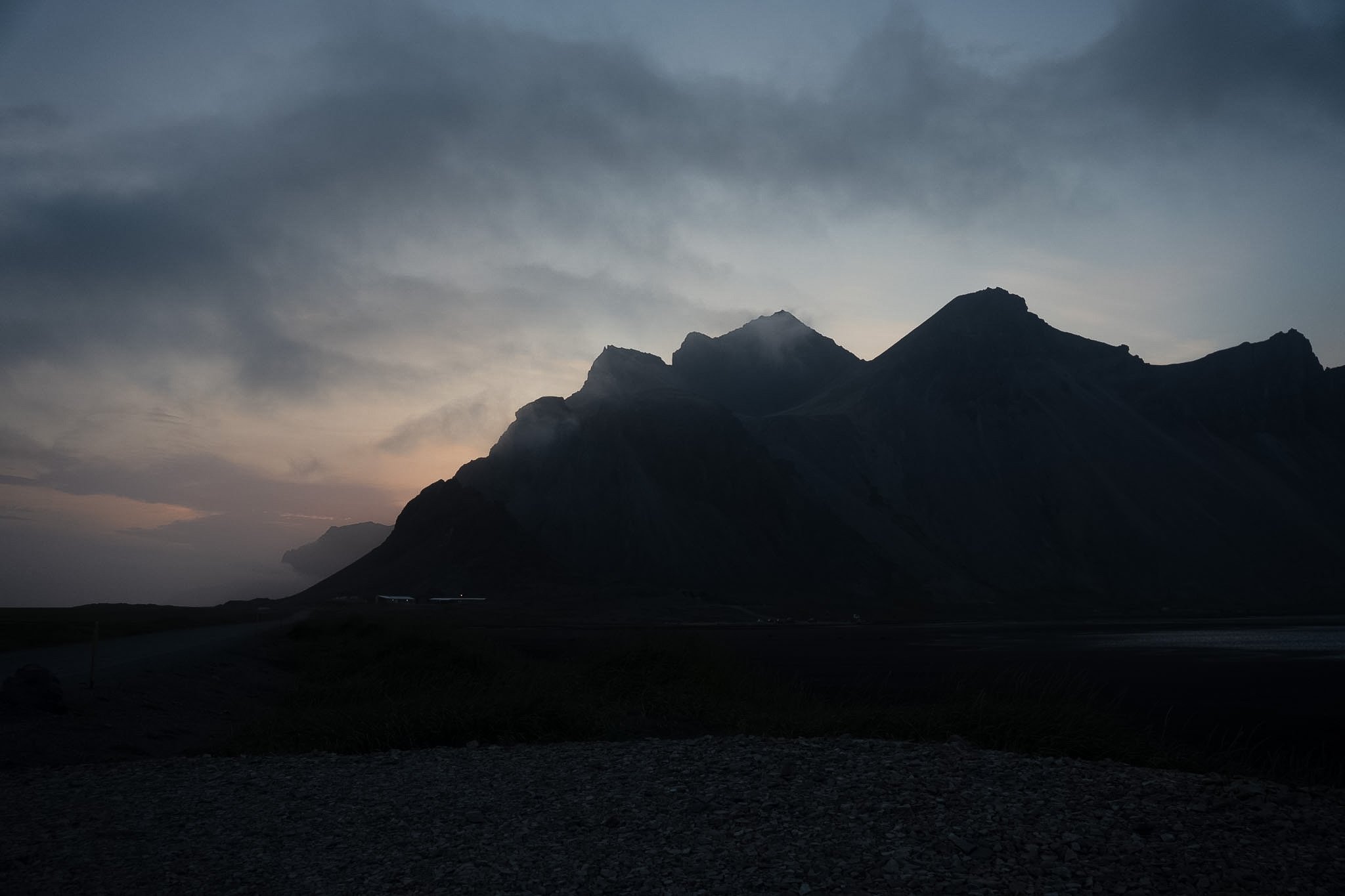 Dark mountain peak silhouetted against twilight sky